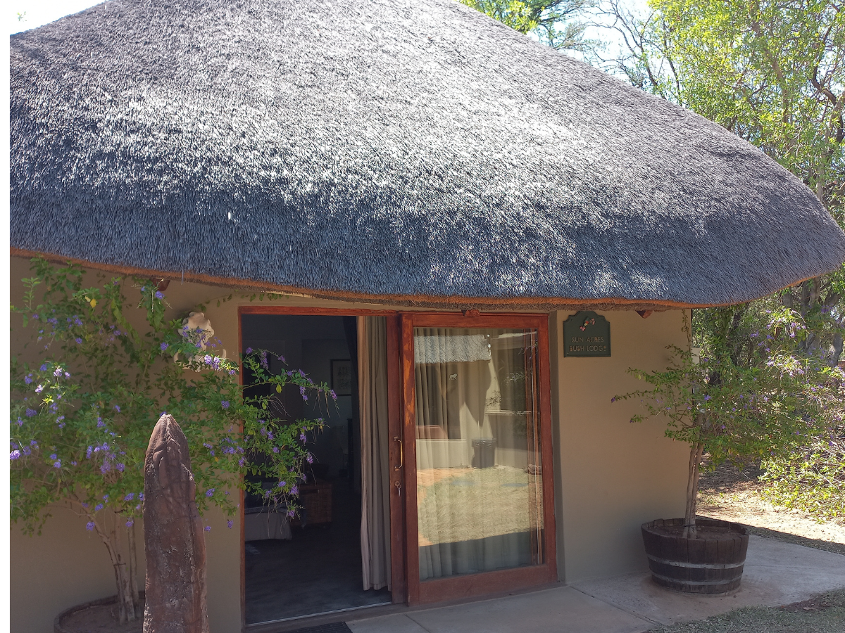 Pool Room exterior with sliding doors opening to pool and bar area at Sun Acres Farm