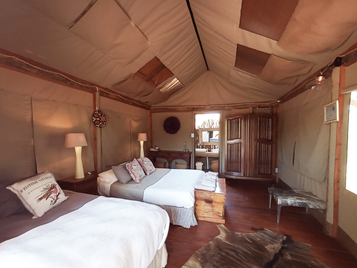 Luxury Safari Tent colonial-style interior with queen and single bed